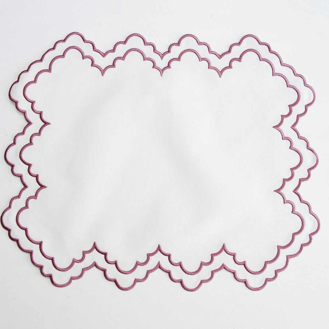 Decorative red lace doily on a white background