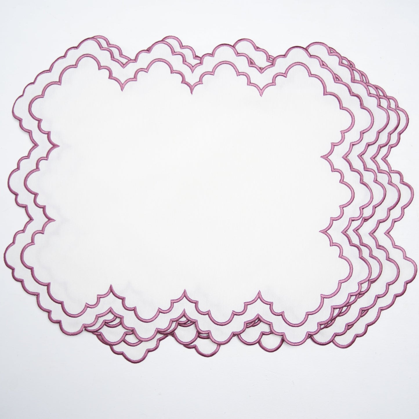Set of pink lace doilies on a light gray background