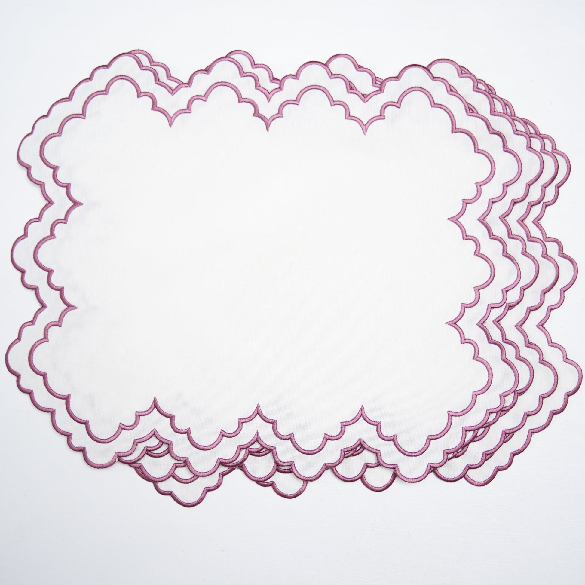 Set of pink lace doilies on a light gray background