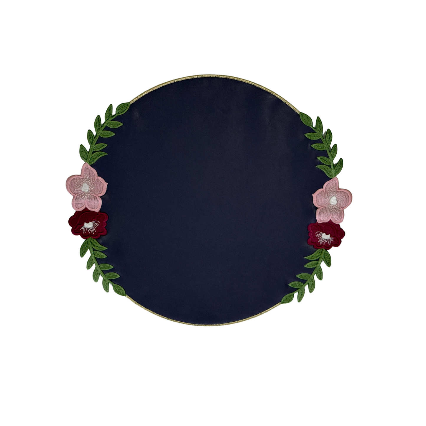 Round faux leather placemat with purple background and floral embroidery around the edge.