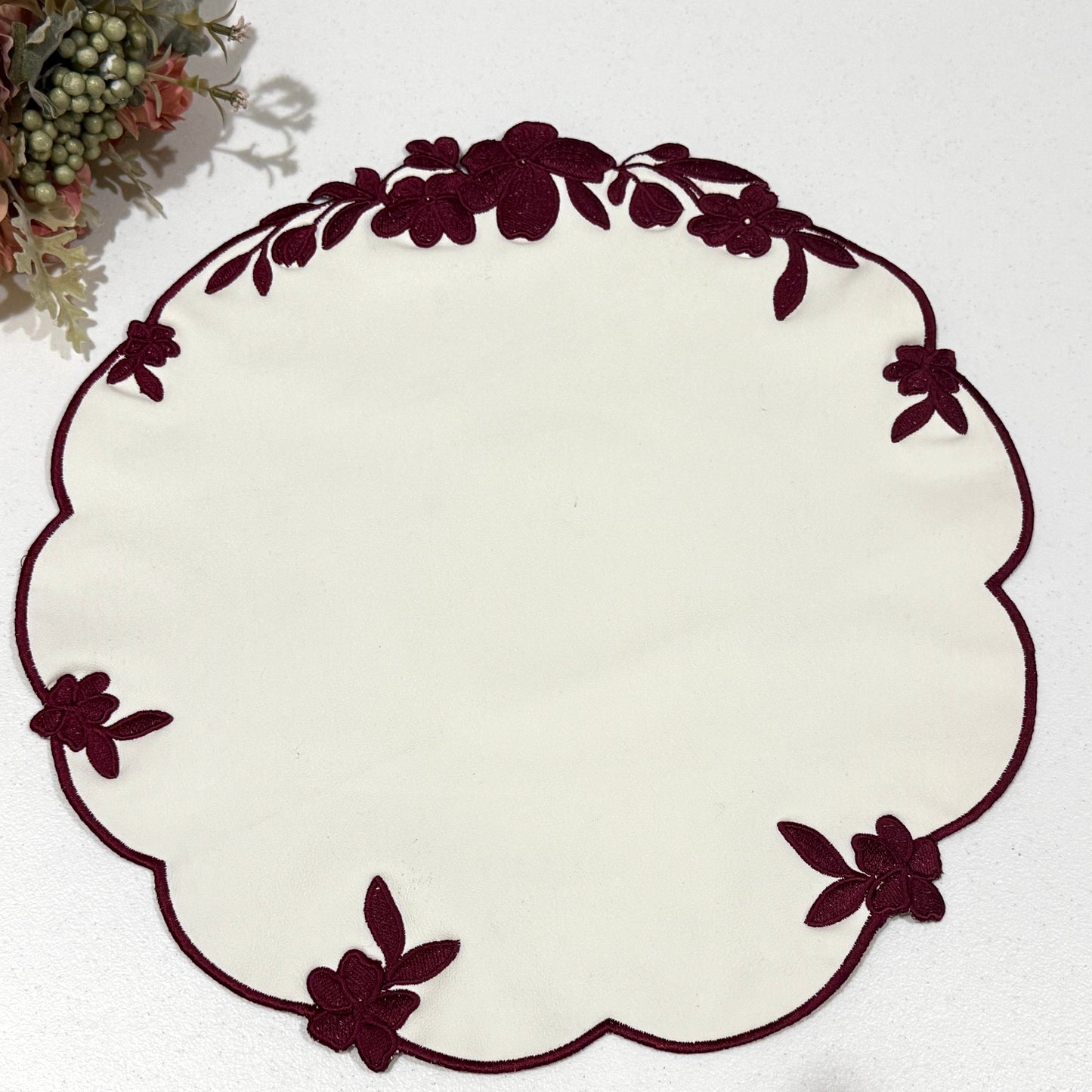 Decorative white plate with brown floral rim on a white background