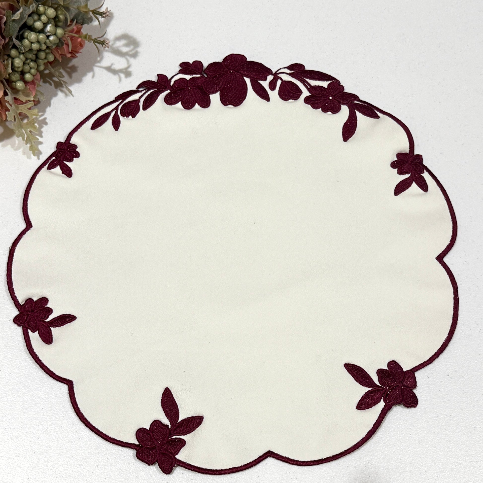 Decorative white plate with brown floral rim on a white background
