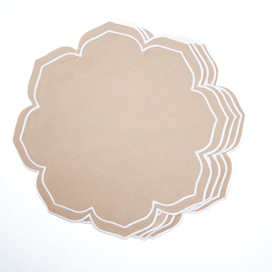 Decorative beige placemat with white scalloped edge on a light gray background