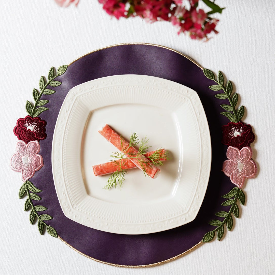 Decorative plate with a floral rim on a white background