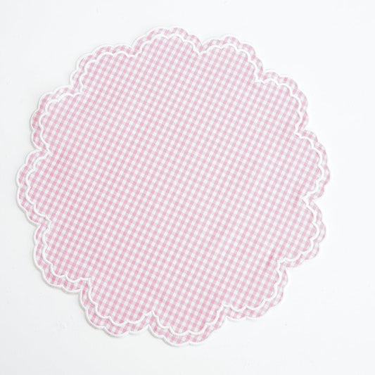 Pink checkered doily on a white background