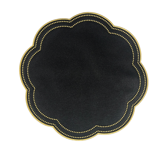 A round black faux leather placemat with gold accents around the edge, displayed on a white background.