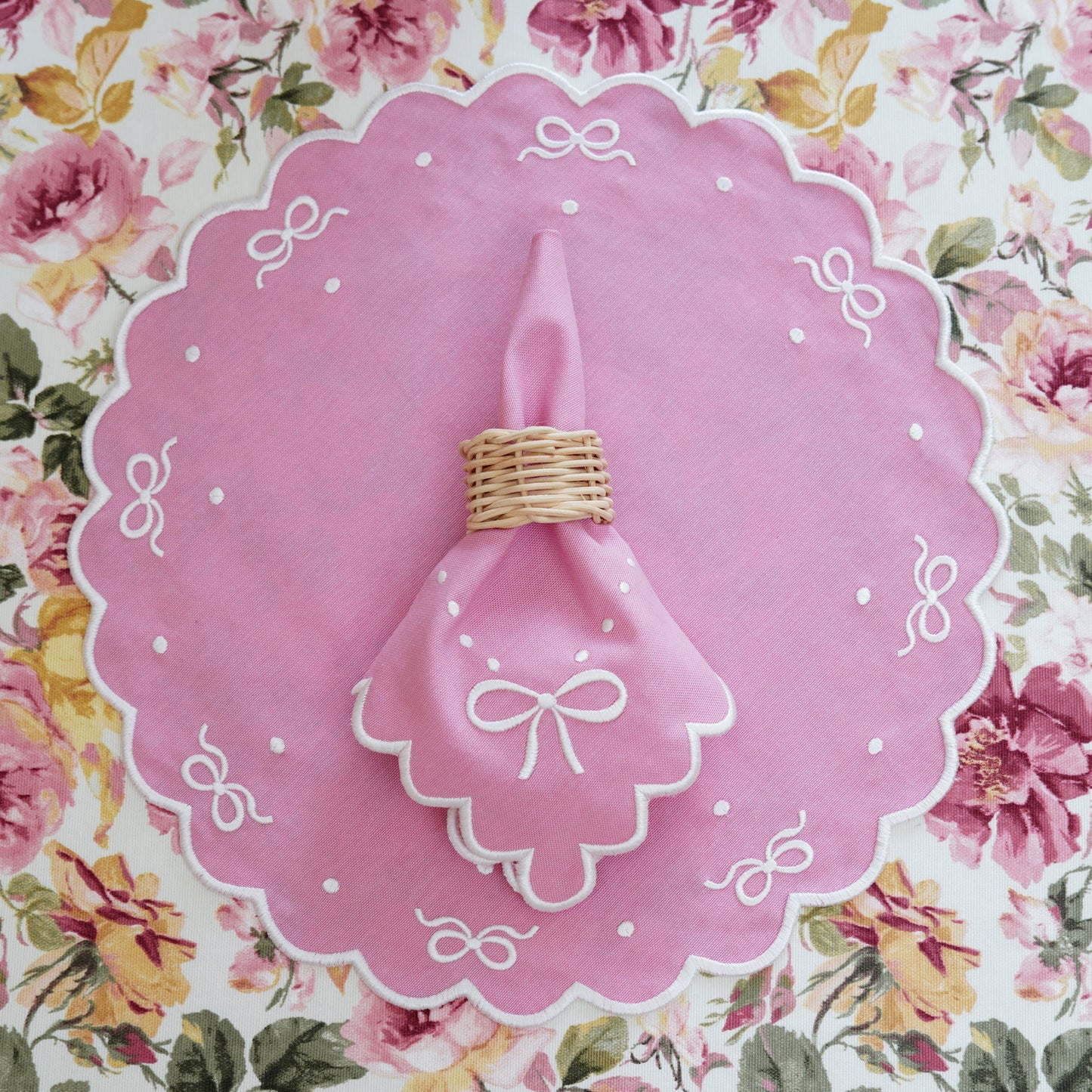 Decorative pink plate with a candle on a floral background