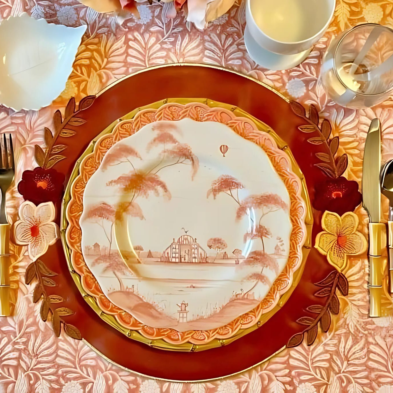 A set table with a dark orange faux leather placemat, a white plate, and silverware. The placemat features a decorative edge and embroidered details.