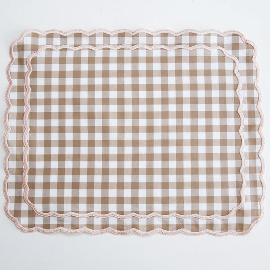 Checkered placemat with scalloped edge on a white background