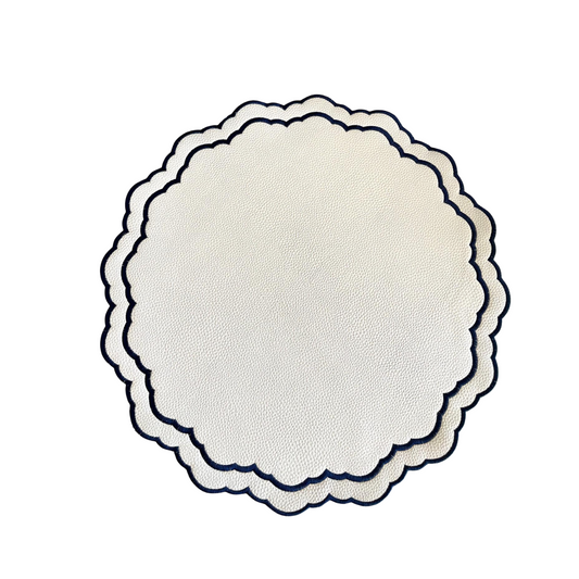A round faux leather placemat with a decorative edge in scarlet, white, and navy blue colors, featuring a subtle floral pattern.