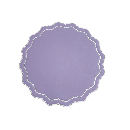 A round scarlet purple white faux leather placemat with a scalloped edge design.