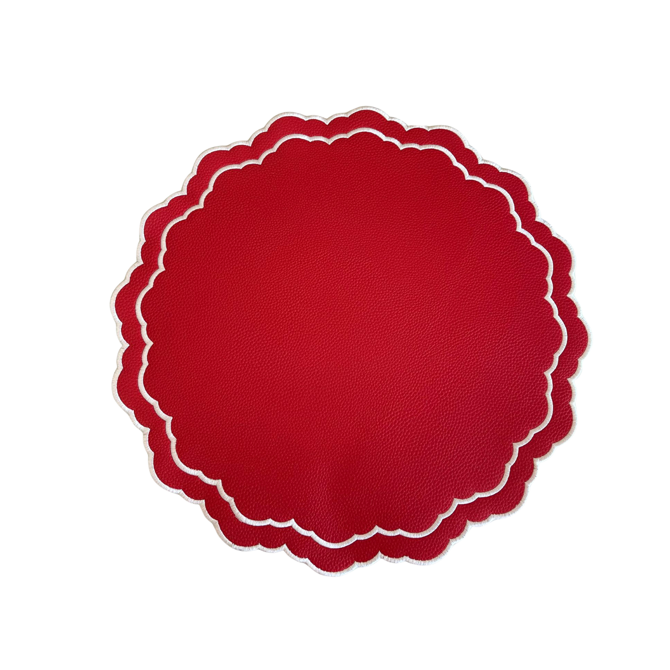 A round, red faux leather placemat with a scalloped edge design on a white background.