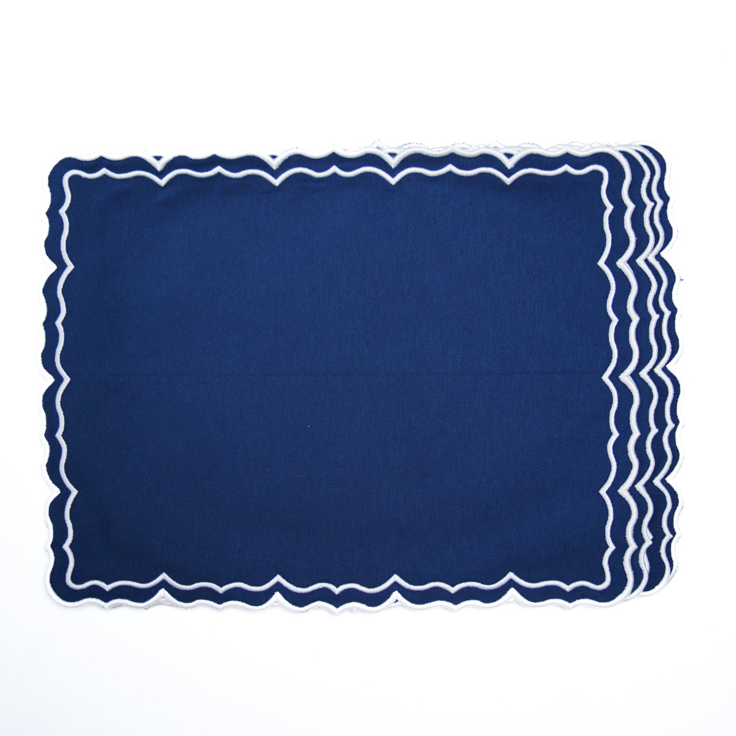 Navy blue placemat with scalloped edge on a white background