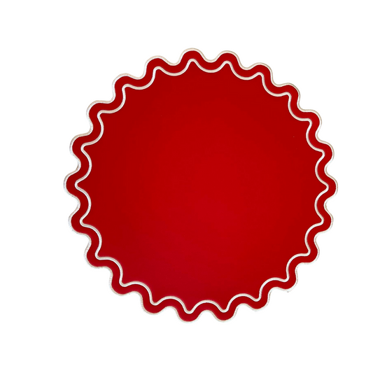 A red faux leather placemat with a wavy edge design.
