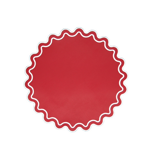 A red faux leather placemat with a scalloped edge design on a white background.