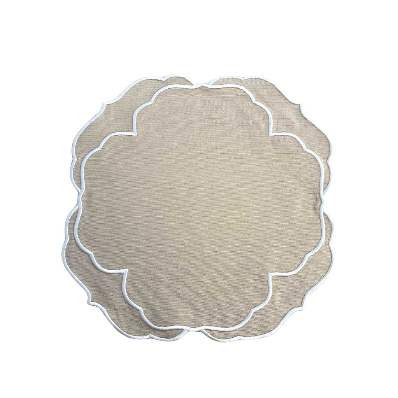 A beige fabric placemat with white embroidered details around the edge, displayed on a white background.