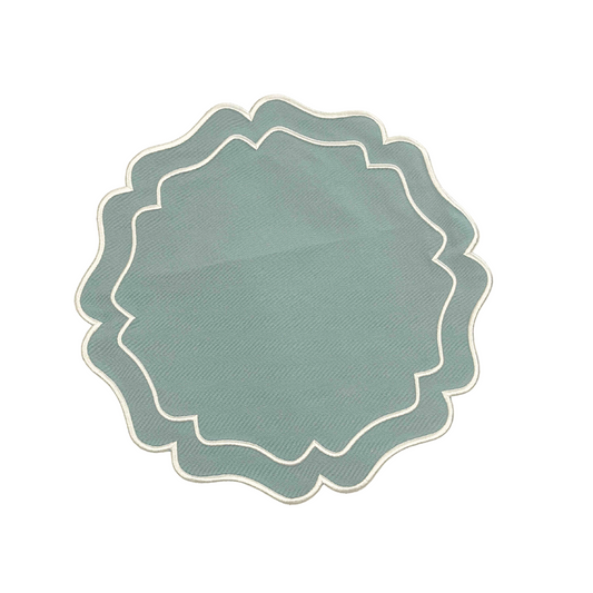 A round green embroidered placemat with a white border laid out on a white background.