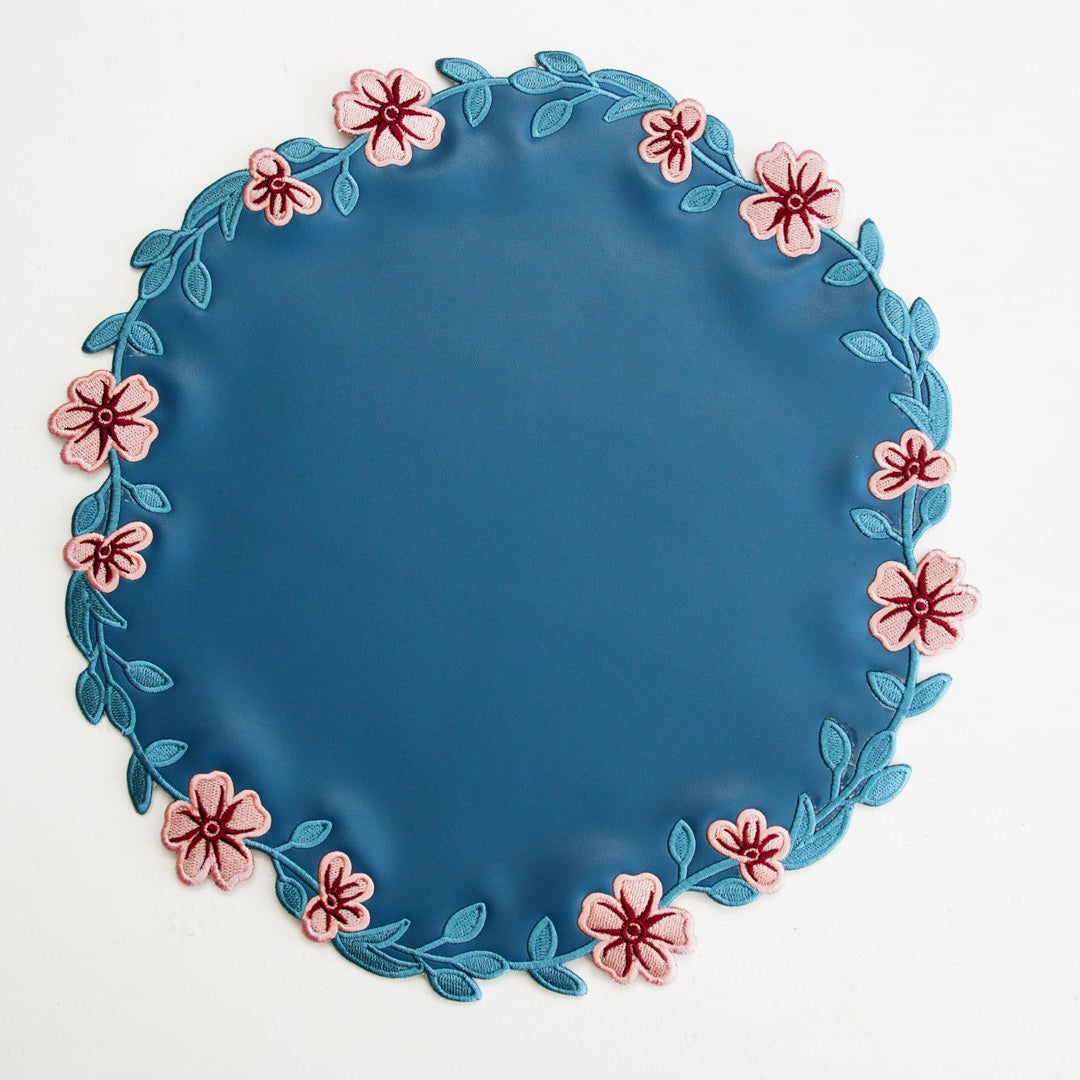 Blue plate with floral decorations on a white background
