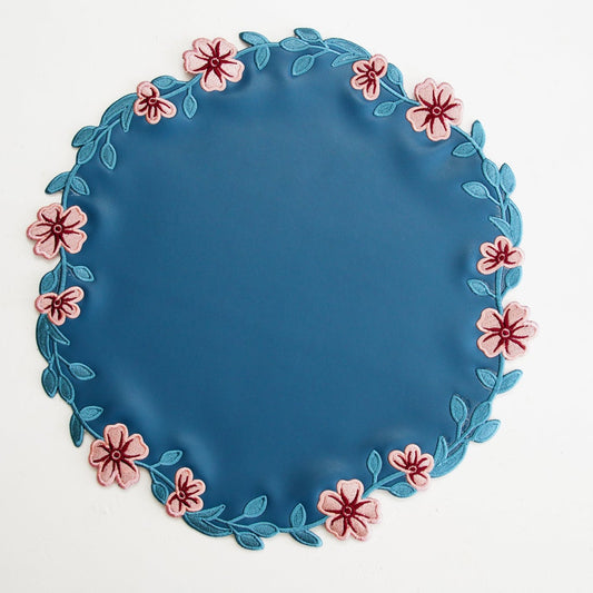 Blue plate with floral decorations on a white background