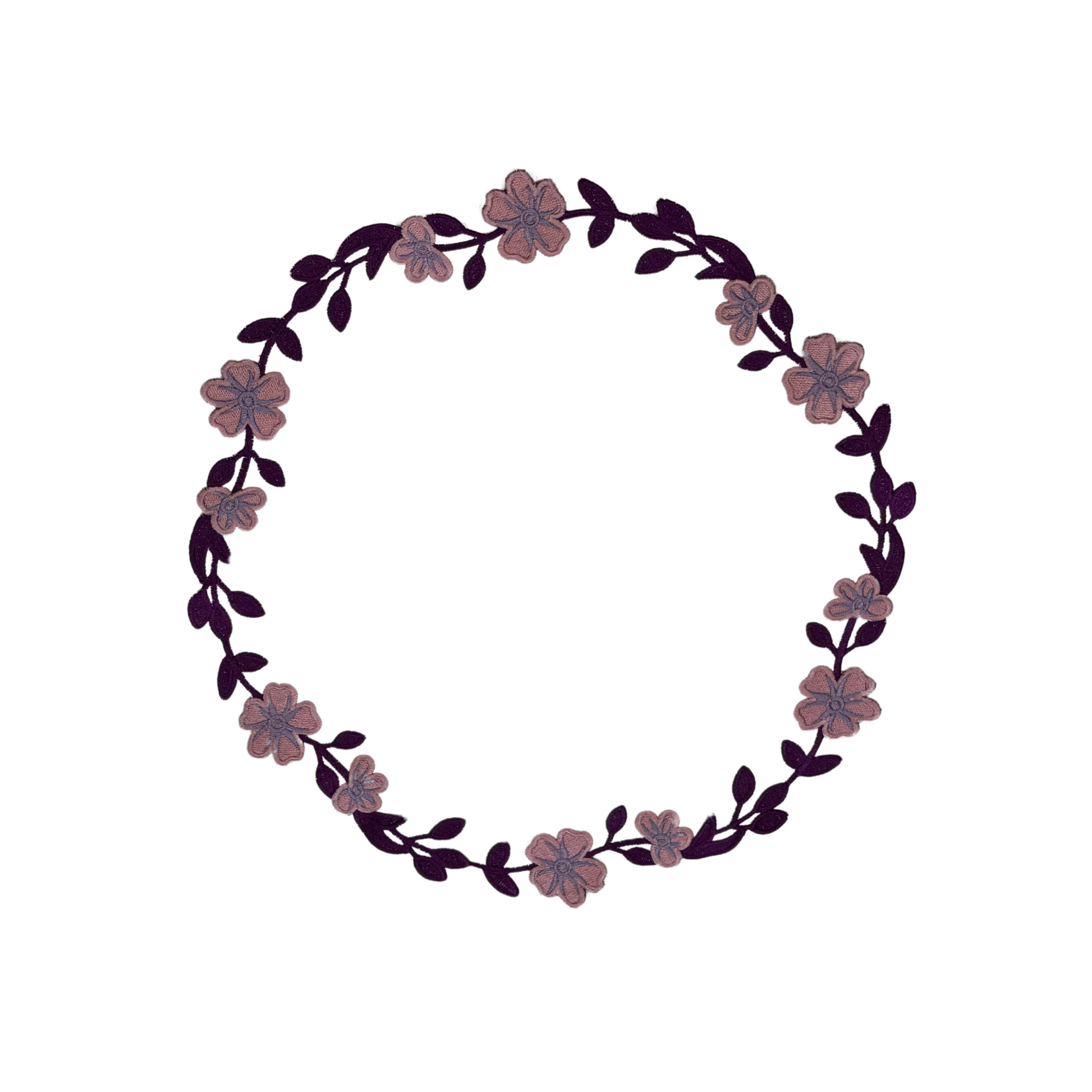 A round faux leather placemat with a purple floral embroidery design around the edge.