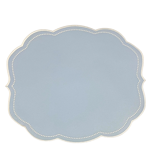 A round placemat with a light blue velour surface and a decorative edge on a white background.