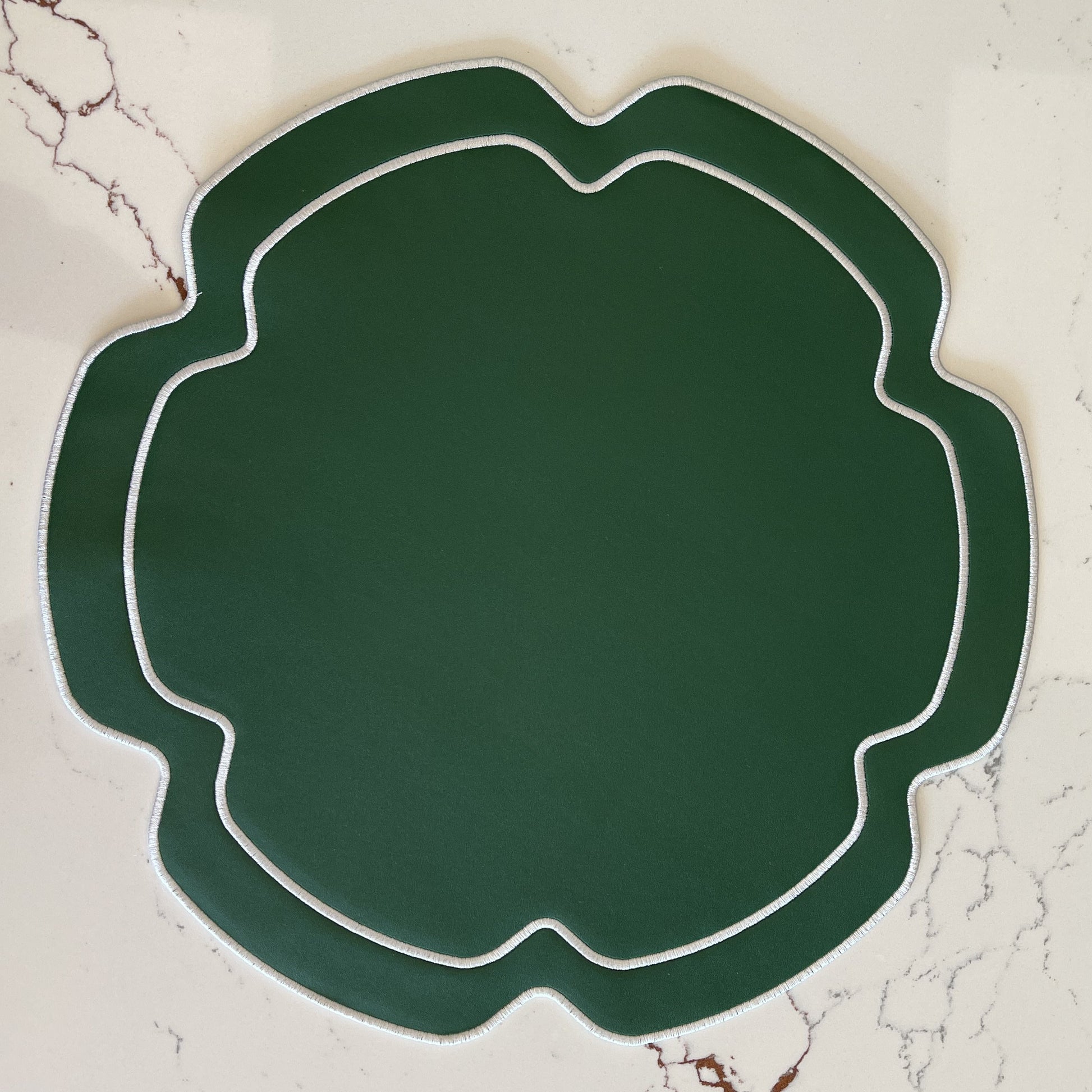 Green decorative plate on a marble surface