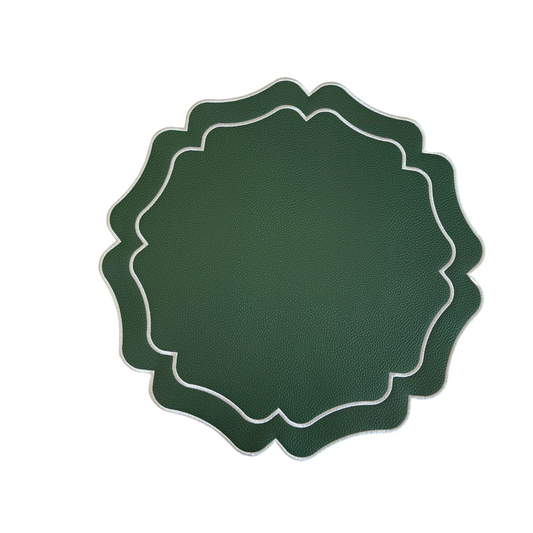 A round green faux leather placemat with white embroidered geometric patterns around the edge.