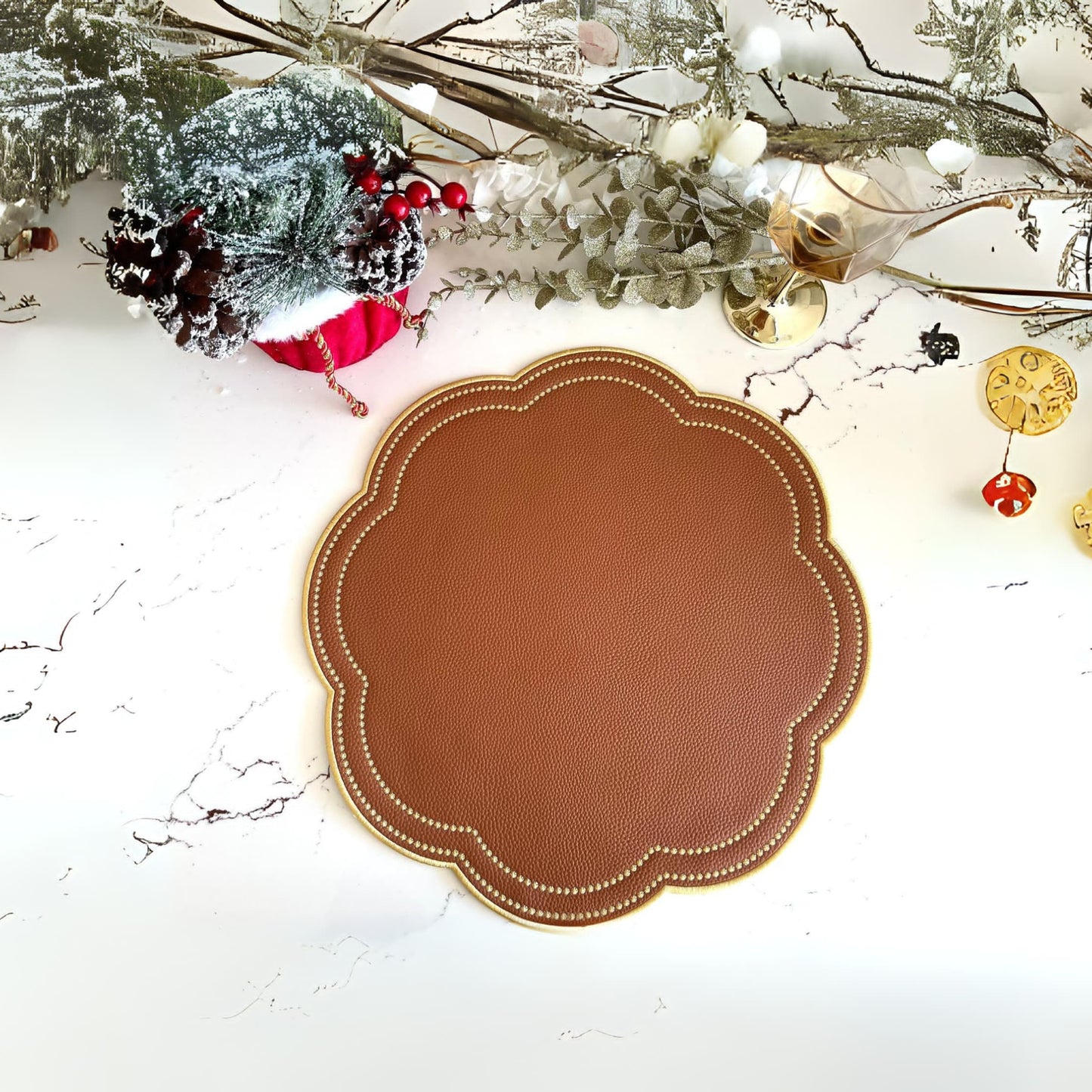 A brown faux leather placemat with a decorative pattern, displayed on a table with holiday decorations in the background.