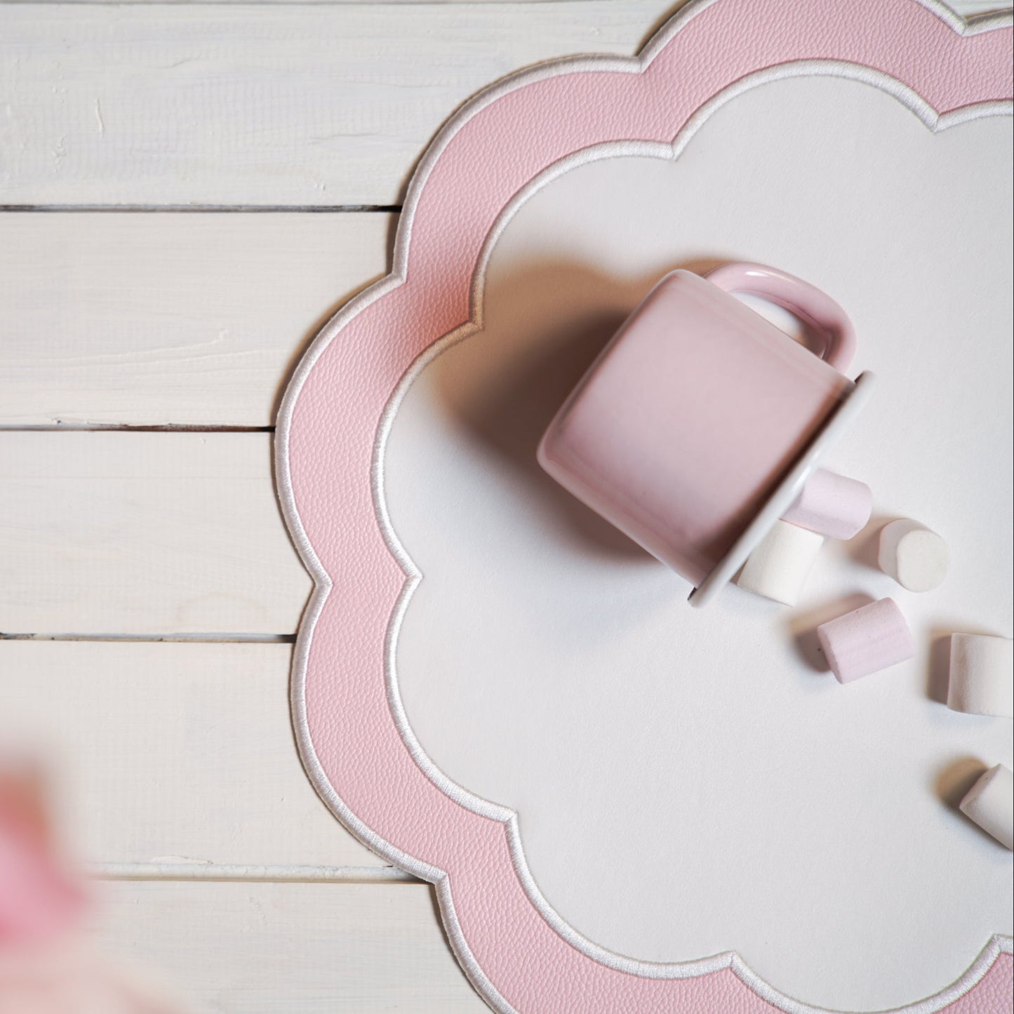 Pink mug and cookies on a decorative pink and white plate with scalloped edge.